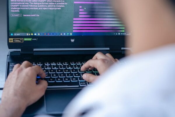 a man sitting in front of a laptop computer