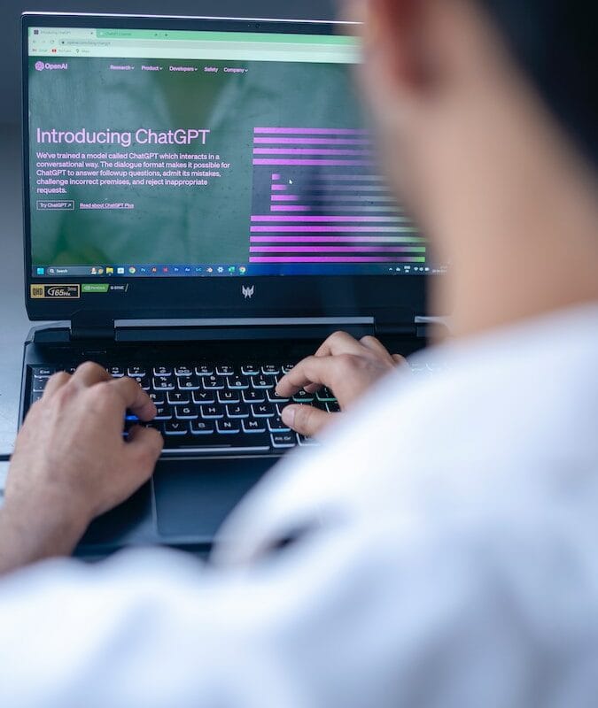 a man sitting in front of a laptop computer