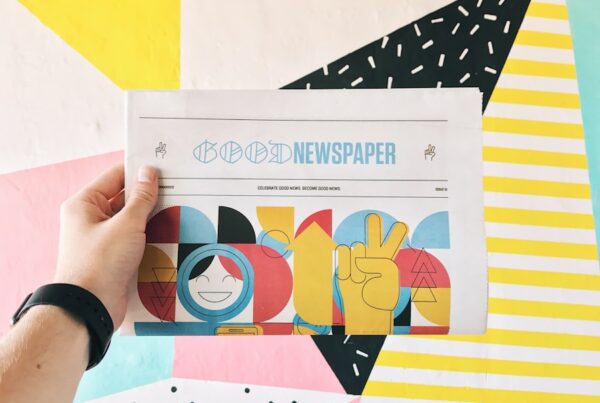 person holding newspaper article