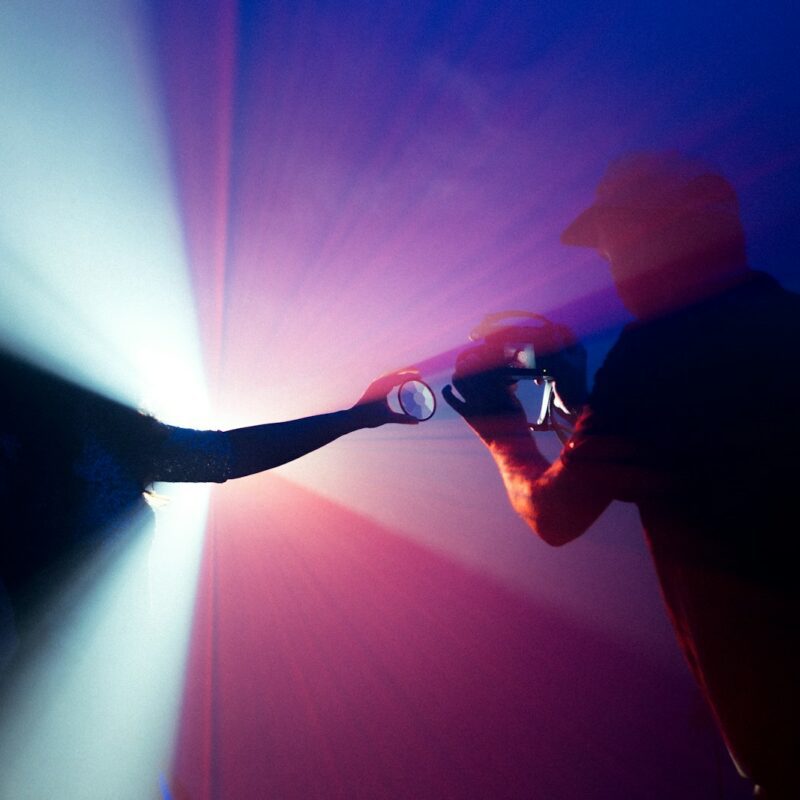 man in black jacket holding camera