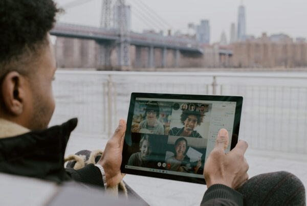 person in black long sleeve shirt holding black tablet Surface device