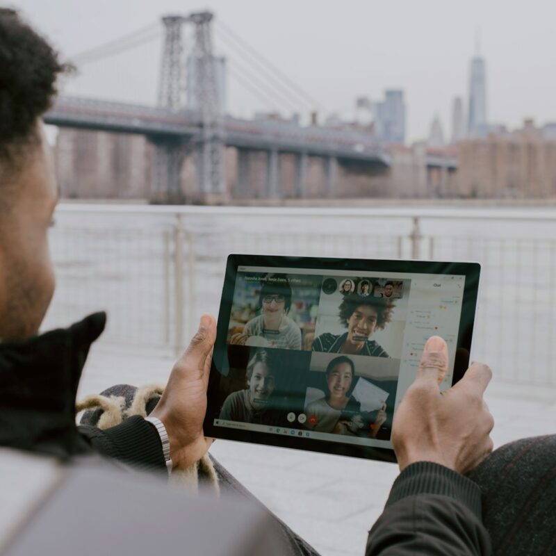 person in black long sleeve shirt holding black tablet Surface device